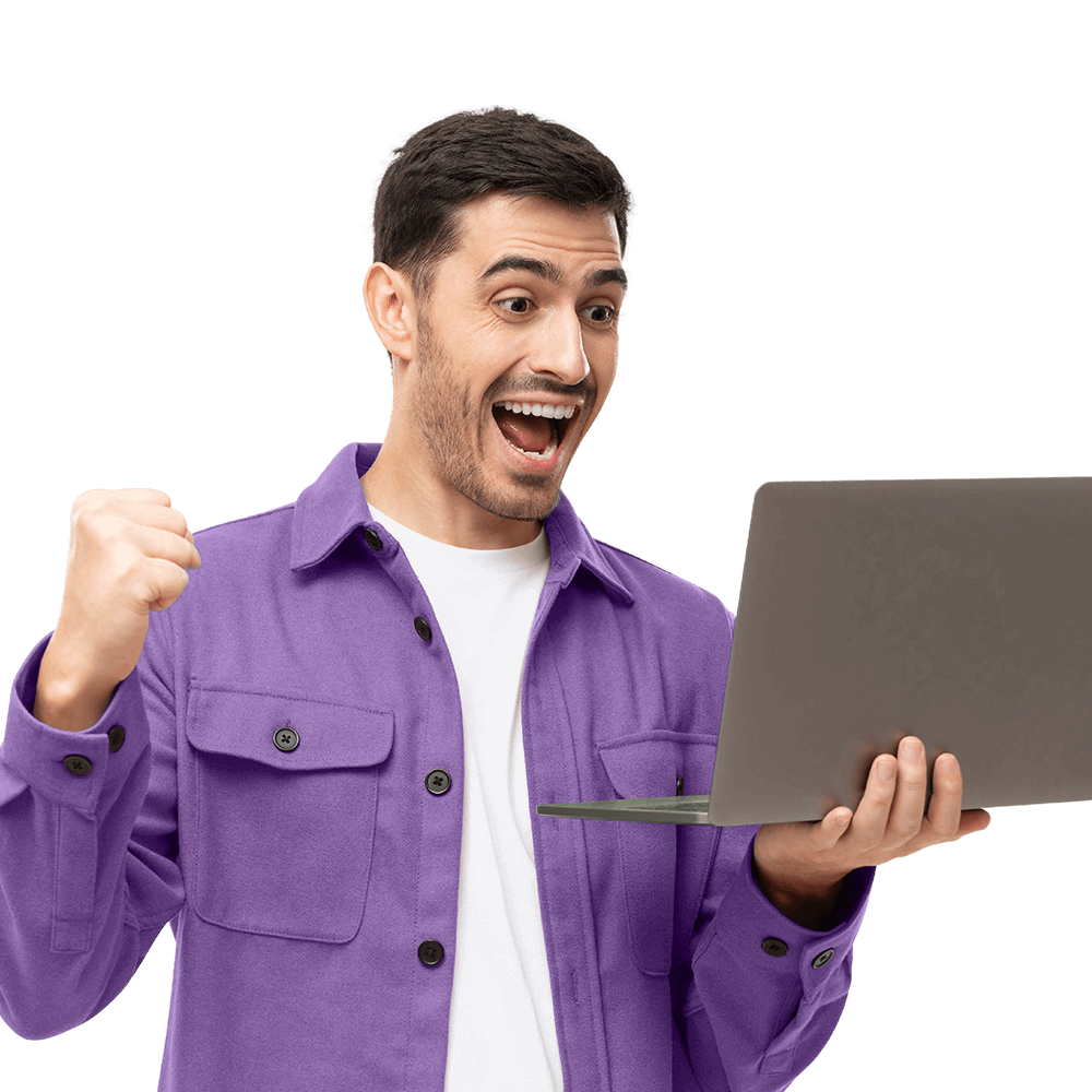 A man holding a purple laptop with his fist raised.